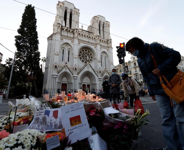 Candles and flowers have been left near the Notre Dame church in Nice in memory of the victims....