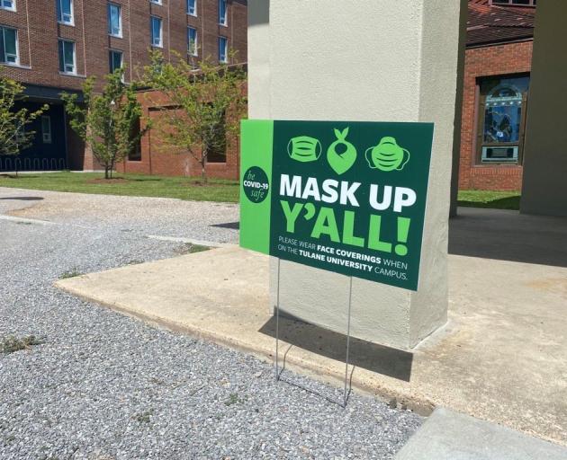 A sign reminds people to wear masks to prevent the spread of Covid-19 at Tulane University in...