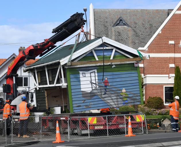 A crane lifts the bus shelter in Drivers Rd, Maori Hill, from its foundations yesterday. PHOTO:...