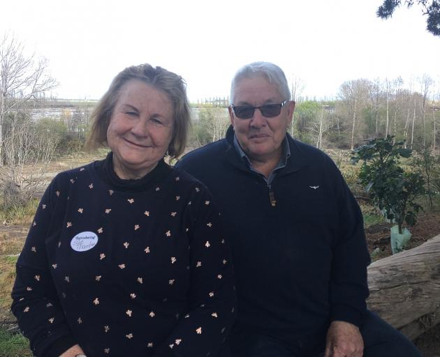 Sue and Ian Thornton, of Ealing, sit on the terrace above their wetland development.

