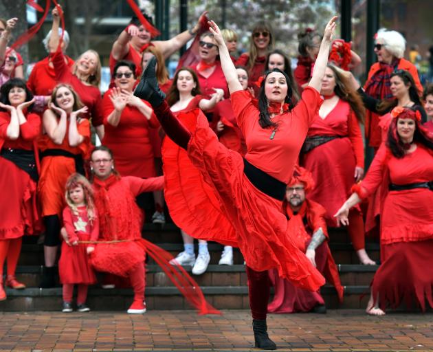 Dance instructor Hannah Rouse leads a large group of people in a re-creation of the music video...