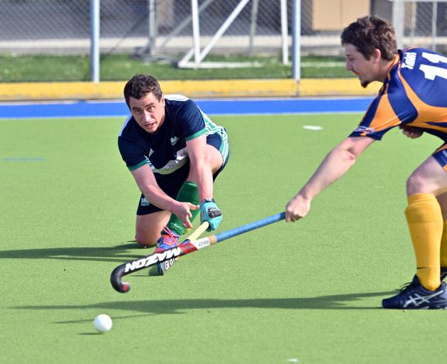 Kings United player Hitaua Arahunga-Doyle (left) looks to move the ball past Taieri Tuataras...