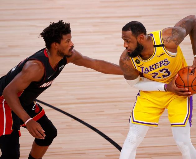 LeBron James is guarded by Jimmy Butler during yesterday's NBA Finals game in Orlando. Photo:...