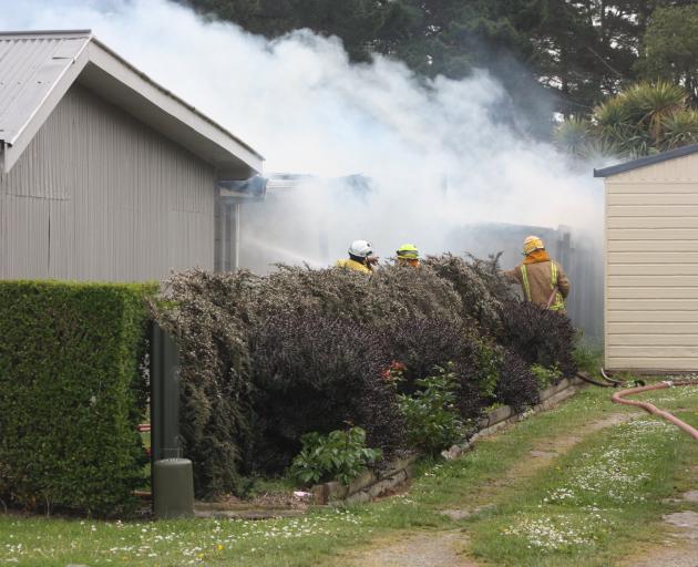 Firefighters battle the blaze in Kakanui Rd yesterday. PHOTO: GUS PATTERSON
