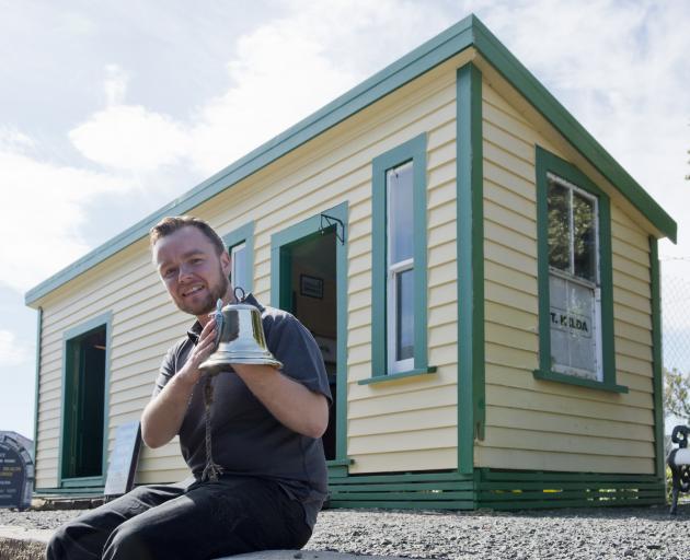 Ocean Beach Railway operations manager Philip Riley polishes a bell outside the newly renovated...