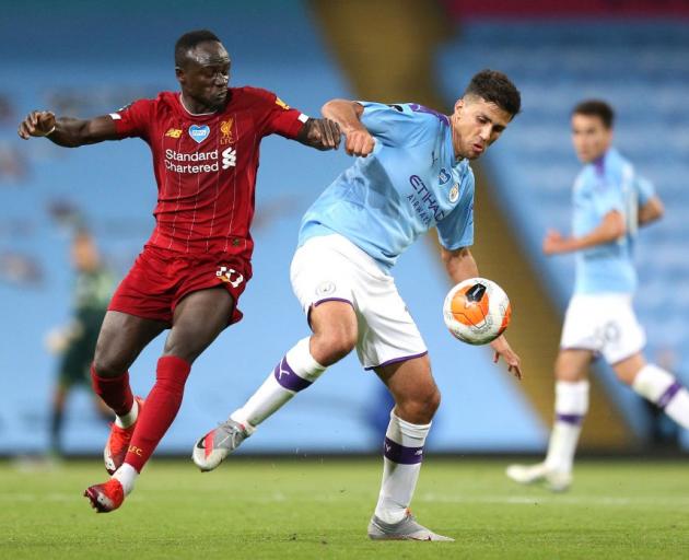 Sadio Mane of Liverpool battles for possession with Rodrigo of Manchester City during the English...