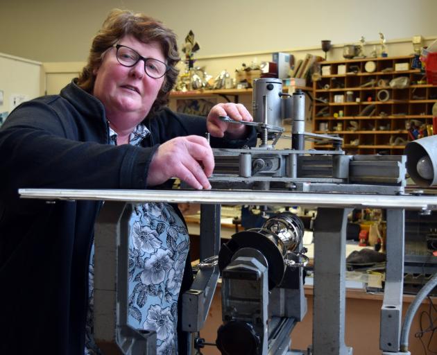 John Swan and Co Ltd owner Janette Armstrong engraves a trophy in her small business in central...