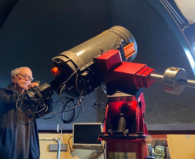 Dunedin Astronomical Society past president and life member Ash Pennell checks the large...