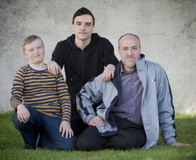 Fashwel family members (from left) Anas (10), Abdel Karim (16) and their father Walid are putting...