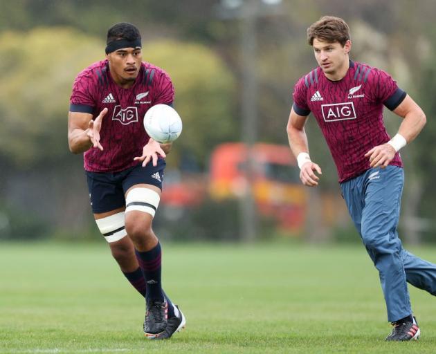 Tupou Vaa'i catches a pass at All Blacks training as Beauden Barrett trails. Photo: Getty Images