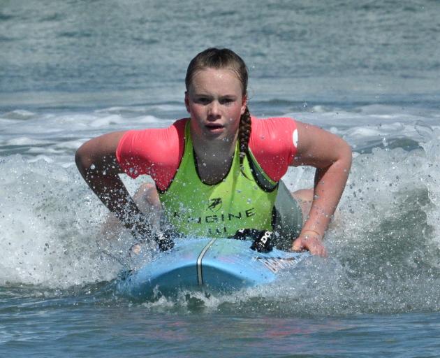 Sophie Matahaere reaches the sand to be the first paddleboarder home in the White Island race on...