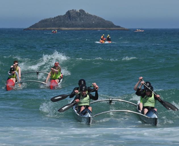 A Kaka Point crew leads a Warrington crew to the beach in the 51st White Island race. PHOTOS:...