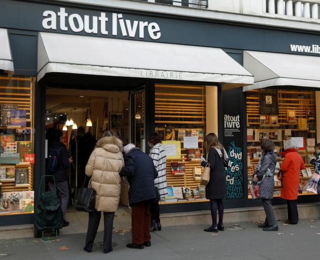 People queue at the 'click and collect' service of a Paris bookshop. Photo: Reuters