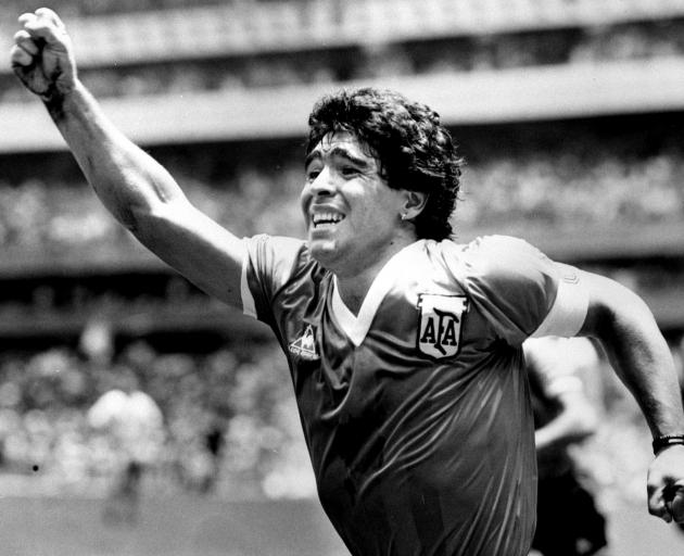 Maradona celebrates after scoring his game winning goal against England in their World Cup...