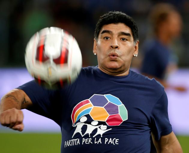 Diego Maradona warms up before the start of a special interreligious "Match for Peace" at the...