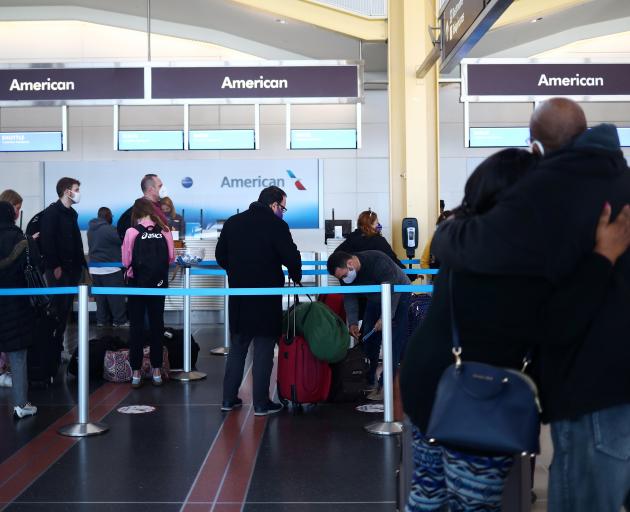 People queue at Reagan National Airport in Washington ahead of the Thanksgiving holiday. Photo:...