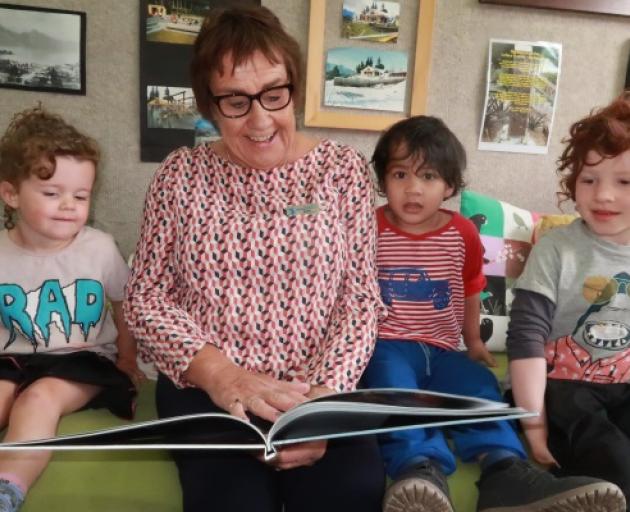 Retiring Wakatipu Kindergarten head teacher Sally Hogg reading to, from left, Stella Burrows, 3,...