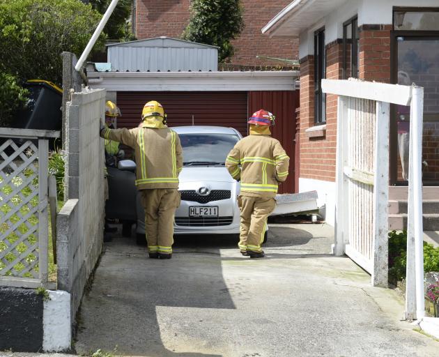 Firefighters in Gloucester St, Andersons Bay, Dunedin, after high winds blew the roof off this...