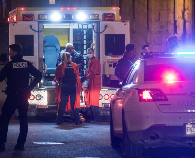 A person is treated by an ambulance crew in an area where multiple people were stabbed in Quebec City. Photo: Reuters