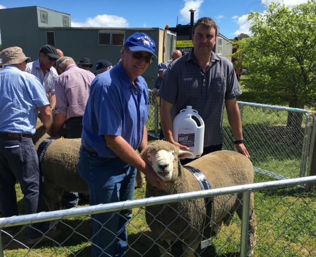 West Melton farmer Robin Wilson is congratulated by the sponsor, Boehringer territory manager...