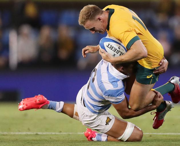 Wallaby Reece Hodge is tackled by Argentina's Pablo Matera at Newcastle's McDonald Jones Stadium....