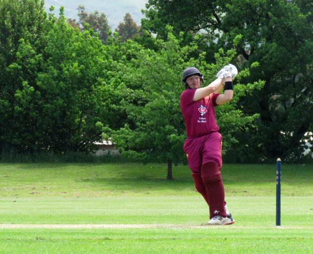 North East Valley batsman Llew Johnson swats a another deliver in the direction of the boundary...