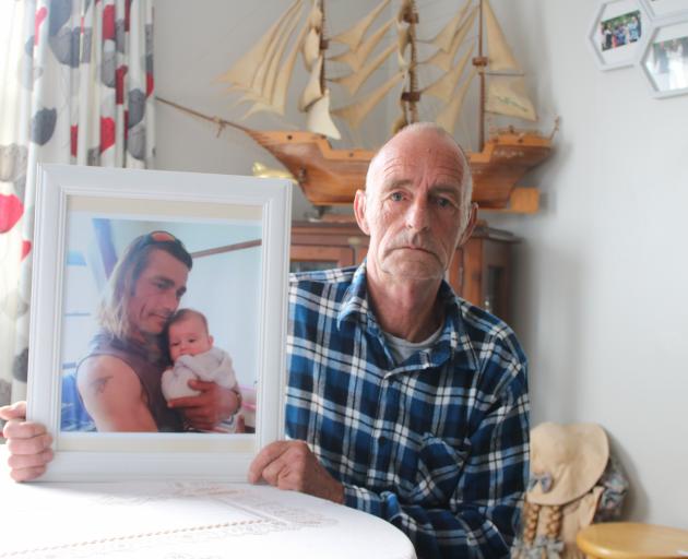Bruce Cawley holds a photo of his stepson, Craig Andrew, who was flown to Dunedin Hospital in a...
