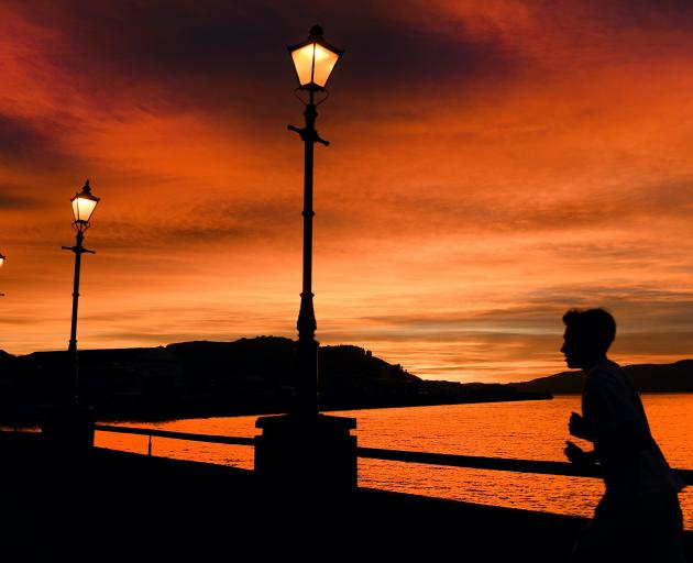 A runner jogs along the Steamer Basin in Dunedin as the sun rises. PHOTO: STEPHEN JAQUIERY