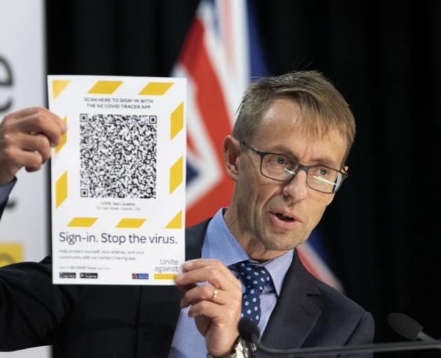 Director-General of Health Dr Ashley Bloomfield shows an example of a QR code which are scanned...