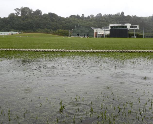 Rain puddles at the boundary edge of the University of Otago Oval yesterday, forcing the...