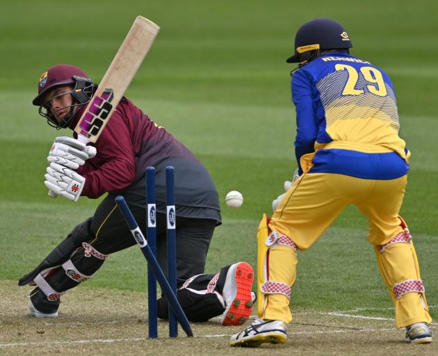 Otago wicketkeeper Mitch Renwick watches as Northern Districts opener Katene Clarke is bowled by...