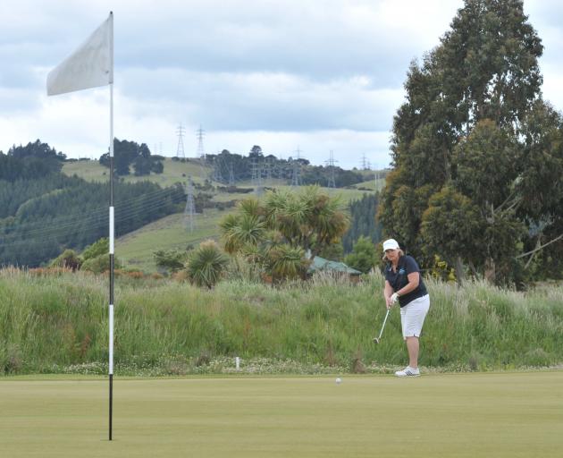 Diane Fahey chips on to the green at the new eighth hole at the Taieri Lakes Golf Club yesterday....
