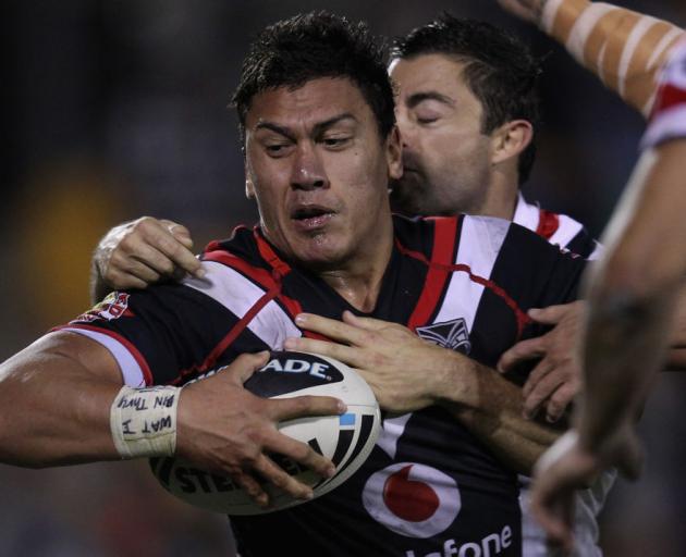 Elijah Taylor of the Warriors is tackled by Anthony Minichiello of the Roosters in 2012. Photo:...