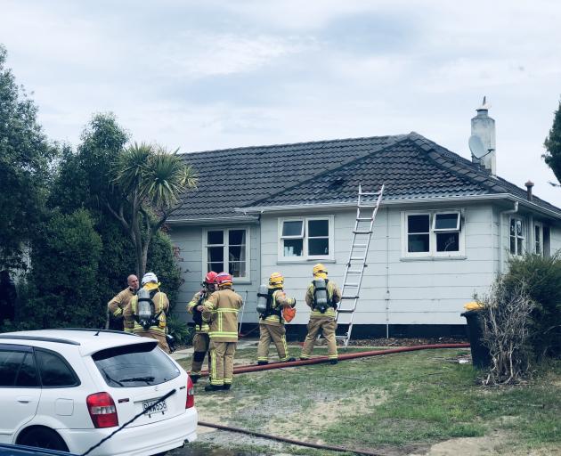 Firefighters at the scene in Port Chalmers this afternoon. Photo: Craig Baxter