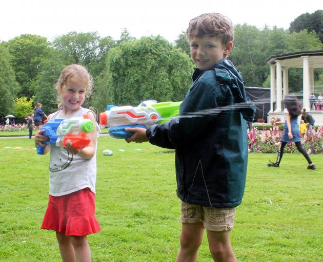 Melina (5) and Alexander Parven (7) were not worried about the rain and had a blast playing with...