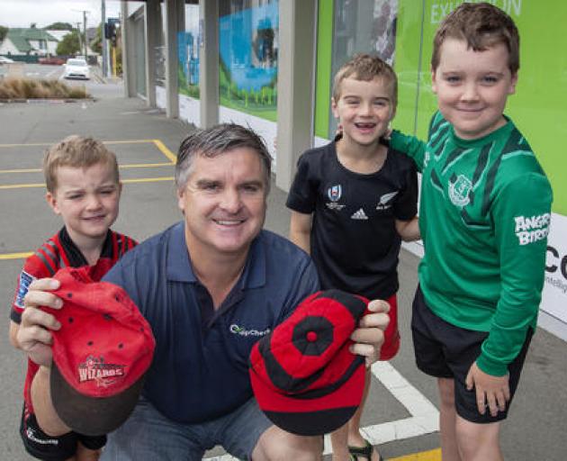 Former Canterbury wicketkeeper Paul Rugg with his two caps and three boys (from left) Spencer,...