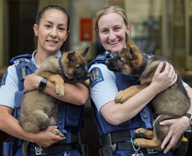 Constable Desiree Hoera (left), holds Harlem, and Constable Larissa Muir holds Harlie, newest...