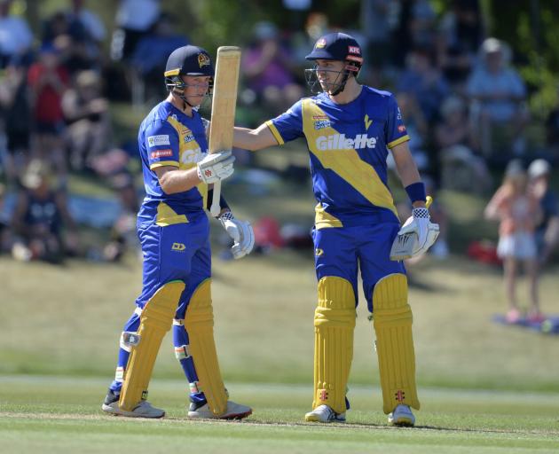 Llew Johnson acknowledges the crowd as Mitch Renwick congratulates him after he scored 50 runs...