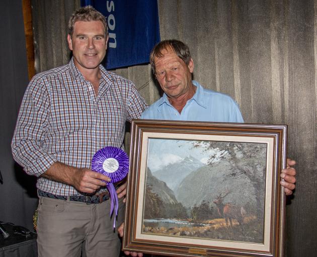 PGG Wrightson’s national velvet manager Tony Cochrane (left) presents Greg Oliver, of Palmerston,...