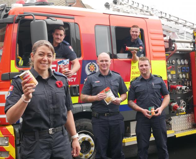 Christmas food and can drive co-ordinator and senior firefighter Aimee Taylor and (from left,...