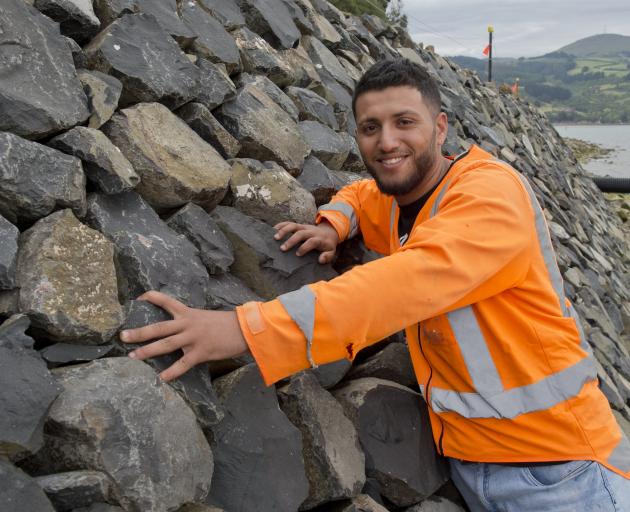 Mohamad Alashour shows off the new stone sea wall in Broad Bay, on Otago Peninsula, which he...