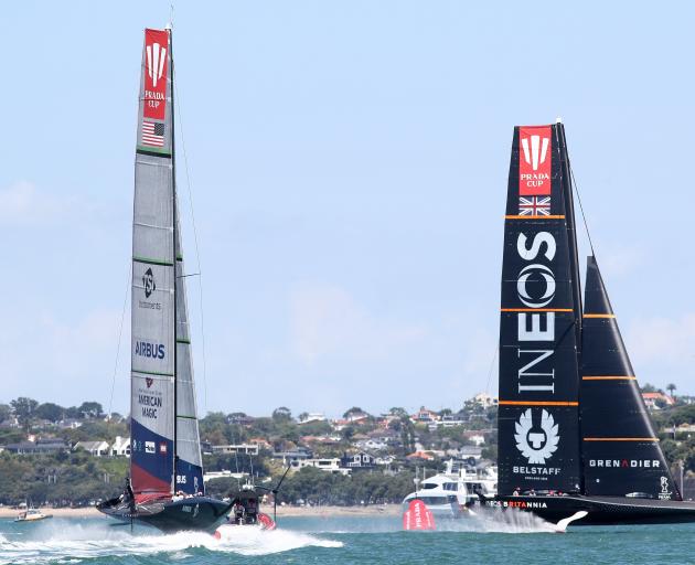 Team UK and American Magic battle it out on the water and are shown in the computer graphics...