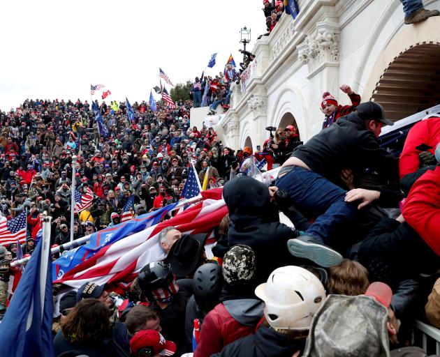 Pro-Trump protesters storm into the US Capitol during clashes with police, during a rally to...