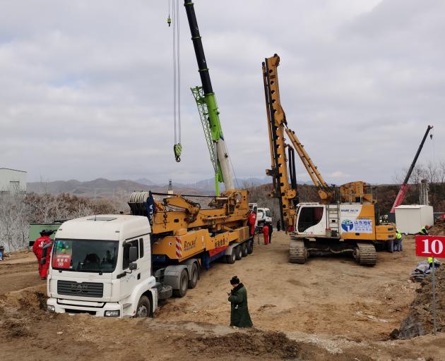 Rescuers at the site where workers are trapped underground after the explosion at the gold mine...