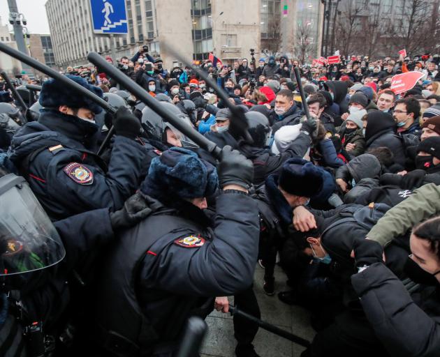 Law enforcement officers clash with protesters during a rally in Moscow on Saturday. Photo: Reuters 