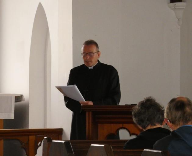 Anglican Bishop of Dunedin the Right Rev Dr Steven Benford reads the paperwork to secularise St...