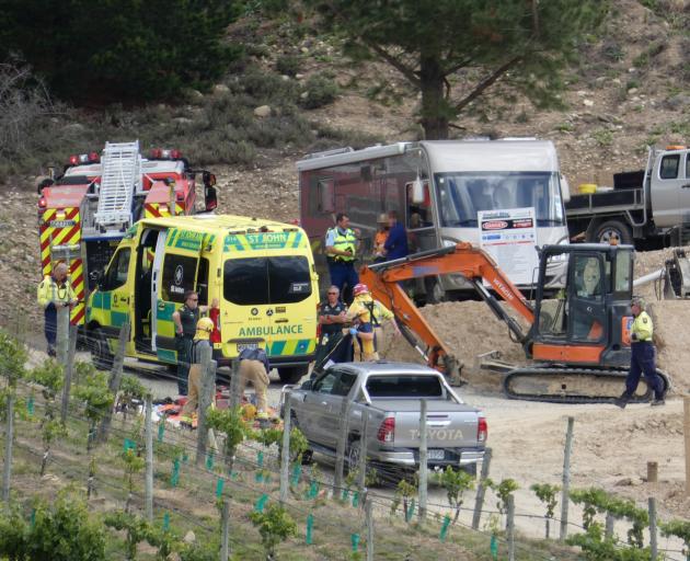 Emergency services and other people work at the scene of a fatal tractor accident yesterday....