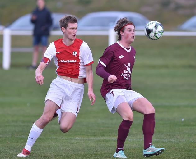 Andrew Ridden (left) and George Thrussell compete for the ball during a match between Caversham...