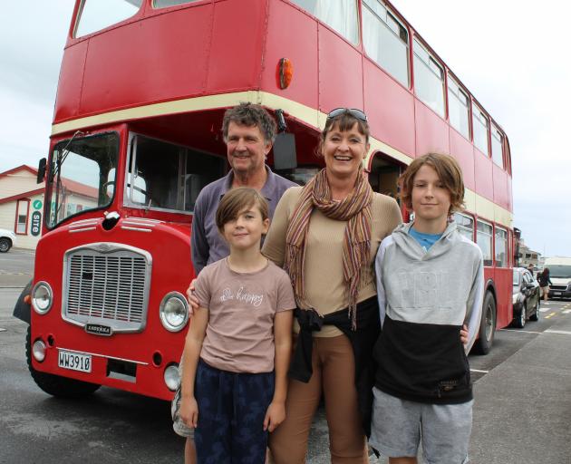 Victoria and Paul Ludemann and their children Linzi and Chase with their double-decker bus,...