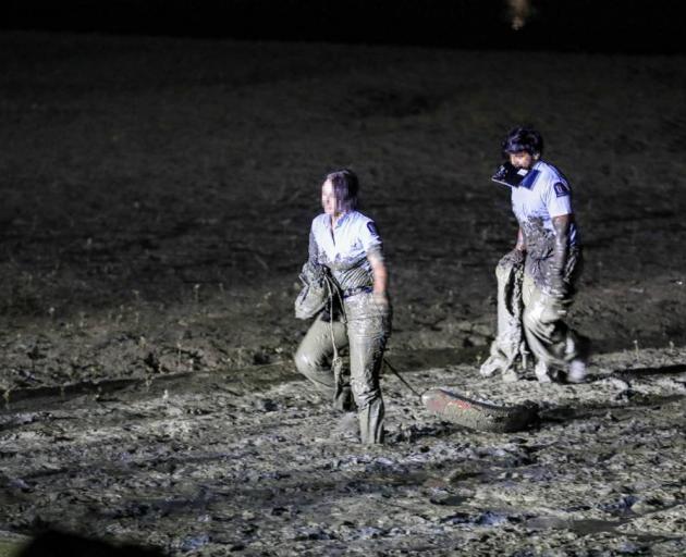 Two police officers got covered in mud trying to save a woman in distress on Friday night. Photo ...